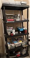 Full view of plastic shelving unit with assorted containers of hardware on four shelves