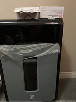 Photo of Tru Red shredder with a visible clear window and a plastic liner inside the waste bin.