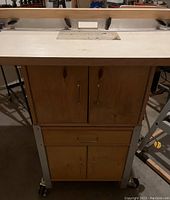 Front view of cabinet with router fence and top plate