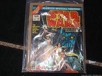 Front cover showing colorful Star Wars Marvel Special Edition comic book #1 from 1977 depicting Darth Vader, Luke Skywalker, Princess Leia, and droids.