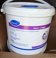 White plastic bucket container of Diversey Oxivir 1 disinfecting wipes with branded label and product details.