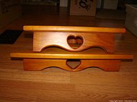 Two wooden heart corner shelves stacked with front view showing heart cutouts and curved design.