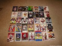 35 Santana Moss Washington Redskins football trading cards spread out on floor showing fronts of cards depicting Moss in player uniform in various action and portrait shots.