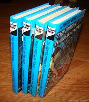 Five Hardy Boys mystery hardcover books standing upright showing titles and volumes 1, 2, 11, and 14.