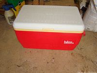 Side view of the large red Igloo cooler with white lid, showing brand logo.