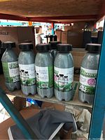 Six grey plastic cannisters on shelf with front labels visible