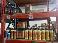 Two-shelf metal rack with assorted Van De Zwaan House & Garden fertilizers
