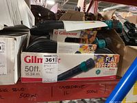 Box containing multiple Gilmour flat weeper hoses in original packaging