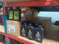 Multiple sealed cases and bottles of both insecticide products on warehouse shelving