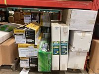 Front view of stacked Sunburst CMh 3100K Spectrum boxes alongside plain white boxes and green-labeled reflector tube boxes on skid