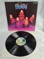 Vinyl record with Deep Purple Burn label placed on white cloth background, taken to show vinyl condition and label authenticity.