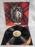 Vinyl LP record on white surface with label showing album and artist information.