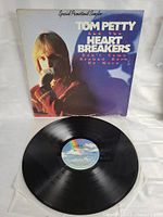 Front view of Tom Petty and the Heartbreakers record LP and sleeve with colorful label visible on record.