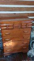 Front view of the wooden dresser showing cabin engraving and drawers