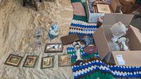 Full display on bed showing decorative tiles, religious statues, case, lighter, ceramic turkey bank, and desk clock.