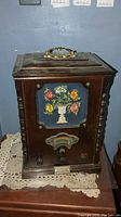 Full view of wooden cabinet AM/FM radio with floral needlepoint front panel, showing general condition and size.