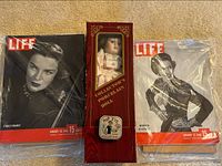 Photo showing two vintage Life magazines and a boxed porcelain doll in original packaging.