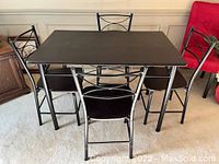 Dining table with four matching chairs showing full set and condition