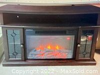 Front view of Masterflame electric fireplace showing flame effect with two side storage cabinets with glass panes and overhead shelf.