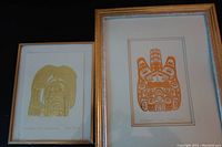 Two framed Haida art prints, one gold 'The Raven Steals the Salmon' and one orange 'Beaver' TTSAANG.