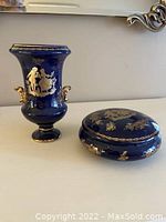 Blue and gold Limoges porcelain vase and oval covered box showing gold handles and crack on lid