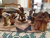 Four Hummel Western German figurines on a table showing full set