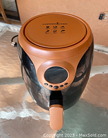 Front top view showing copper color, round viewing window on the cooking basket, digital control buttons, power cord visible.