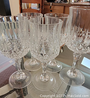 Photo showing six crystal vintage wine glasses with intricate cut glass design on bowls and stems.
