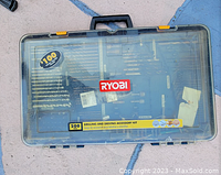 Top view of the Ryobi 200-piece Drilling and Driving Accessory Kit in plastic carrying case on a concrete surface