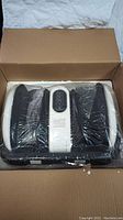 Cloud Massage foot and calf massager in original packaging, wrapped in protective plastic, showing the control panel and padded foot/calves compartments.