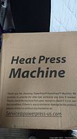 Front of sealed cardboard box with 'Heat Press Machine' text and service email address.
