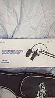 Box of Nnuu XM-900 condenser studio microphone set showing product and model.