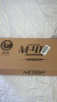 Closed original branded cutout box showing Heckler M-416 label