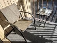 Photo showing one outdoor chair with metal frame and beige mesh seat on balcony