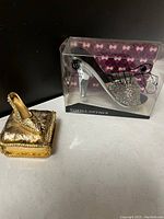 Jeweled clear high heel shoe bottle opener in original plastic packaging with purple patterned back