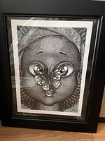 Framed drawing showing entire artwork with face and butterfly details.