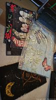 Three rubber mats including the butterfly welcome mat in packaging, seasonal themed area rug, and owl boot scraper mat on floor