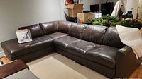 Overall view of two-piece leather sectional with chaise from front left angle