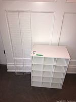 Photo showing both white metal wire shoe shelf and white composite wood shoe rack side by side