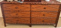 Front view of wicker wood dresser showing six drawers and round knobs