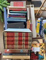 Top view of a box filled with various books including the 5-volume Illustrated Medical Encyclopedia set.