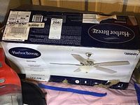 Box showing Harbor Breeze branding and Oxford model name, with product image of ceiling fan at rest.