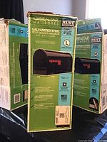 Photo of 3 Gibraltar mailbox boxes showing large (L) and medium (M) sizes, rust resistant galvanized steel, powder coat finish. One box has dents.