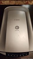 Top view of the Canon CanoScan 4400F scanner showing silver lid with Canon logo and model badge.