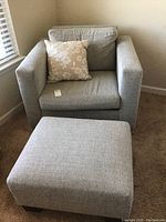 Full view of chair, ottoman, and pillow showing their size and relation to one another.