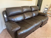 Wide left-front angle view of dark brown faux leather sofa