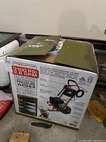 Sealed cardboard box with model label 'Predator Outdoor Power Equipment 3100 PSI 2.8 GPM Gas Powered Pressure Washer'.