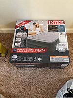 Boxed Intex air mattress showing brand, product name, and visual of the mattress.