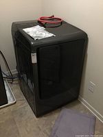 Full view of dryer unit against wall