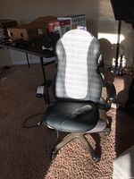 Full view of the black and gray Homedics shiatsu massage office chair showing ergonomic design and five caster wheels.